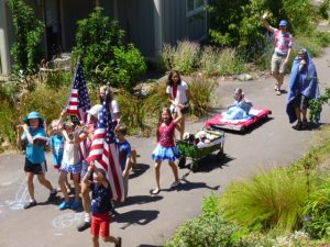 Coho musicians in a rousing Stars and Stripes Forever. Lots of parade waves. Is that a wagon full of stuffed animals?